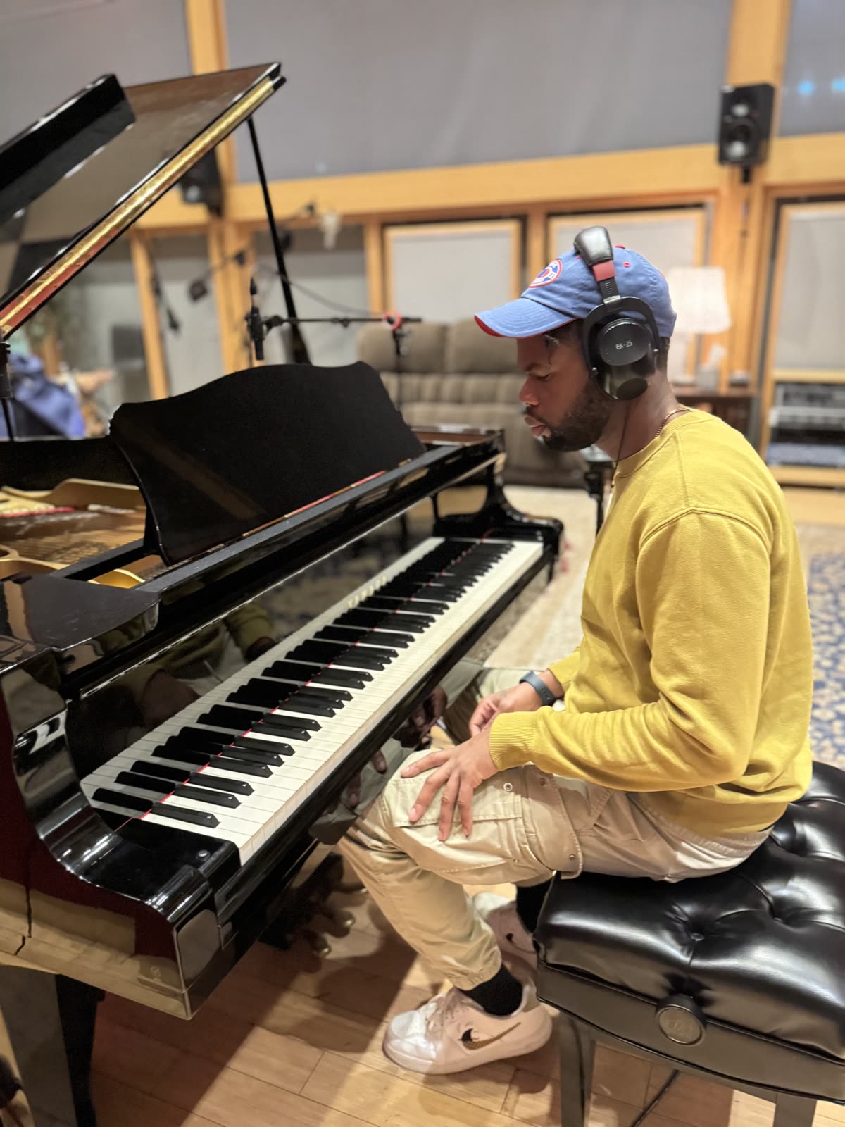 Seated at the grand piano at Shock City in headphones.