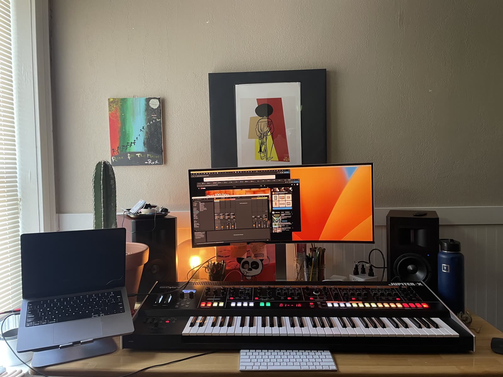 The home studio: desk, monitor, MIDI keyboard, and a session open on screen.