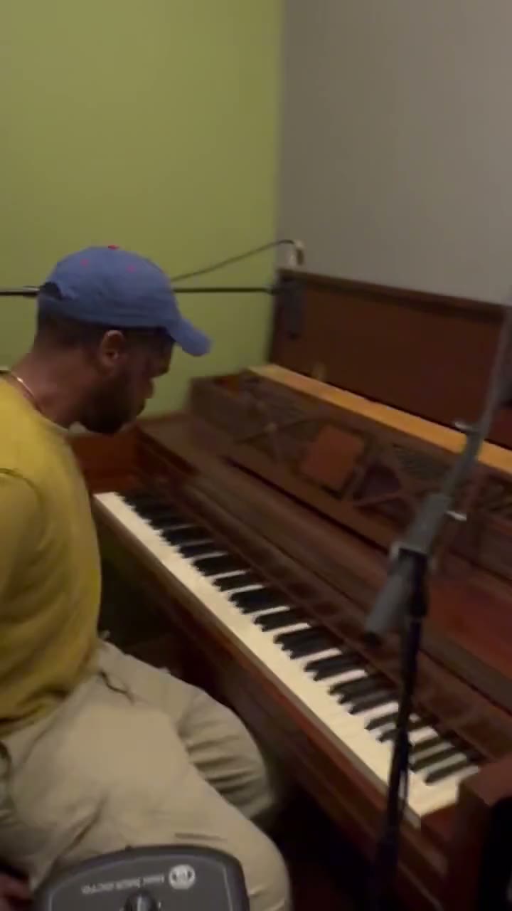 Setting a microphone against the upright in a practice room.