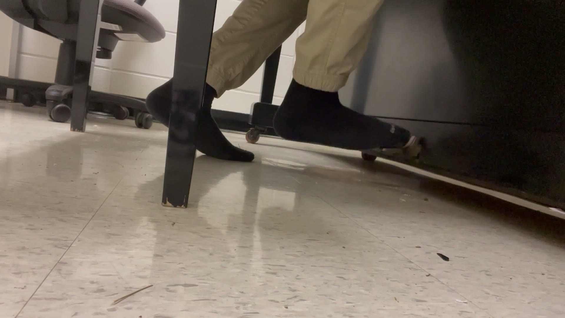 A close shot of a foot working the sustain pedal.