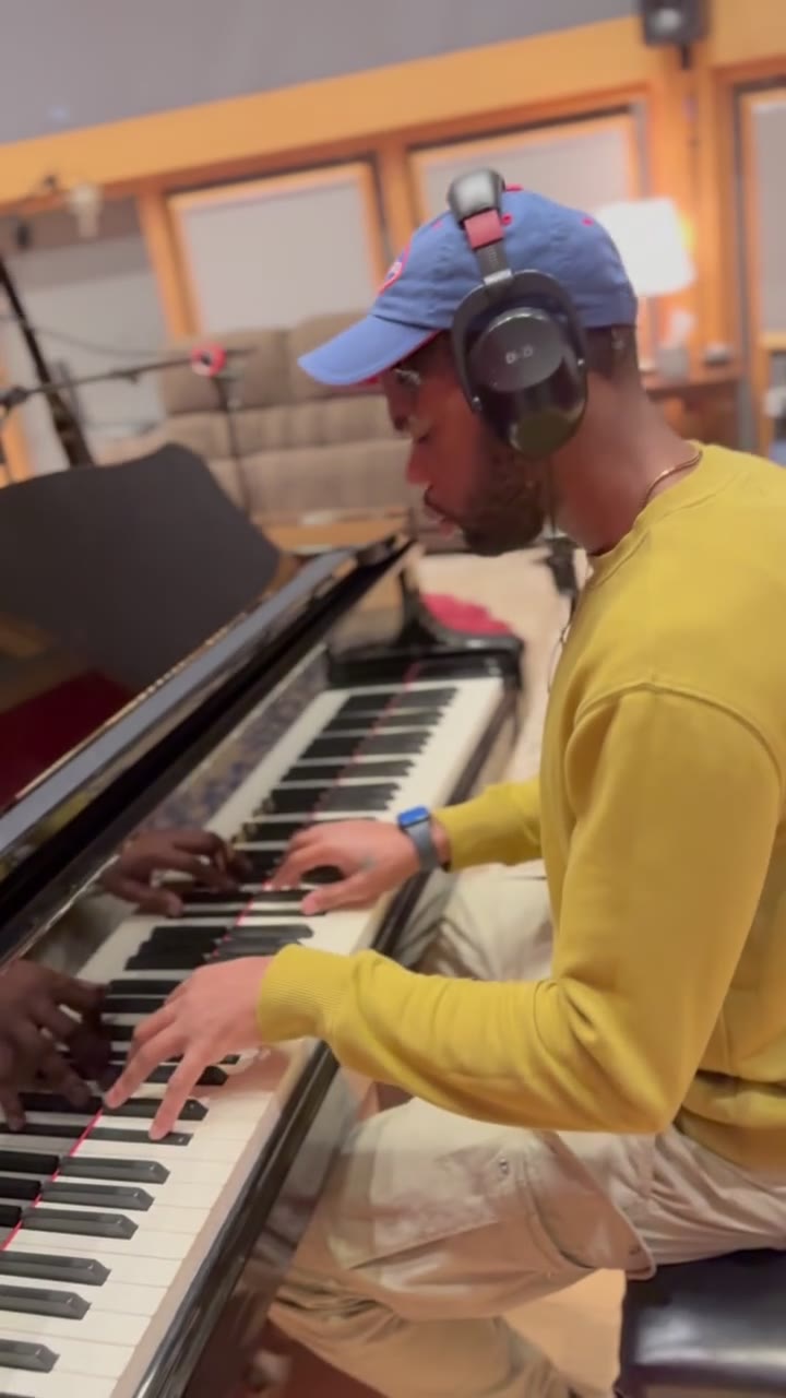 Playing the grand piano in headphones.