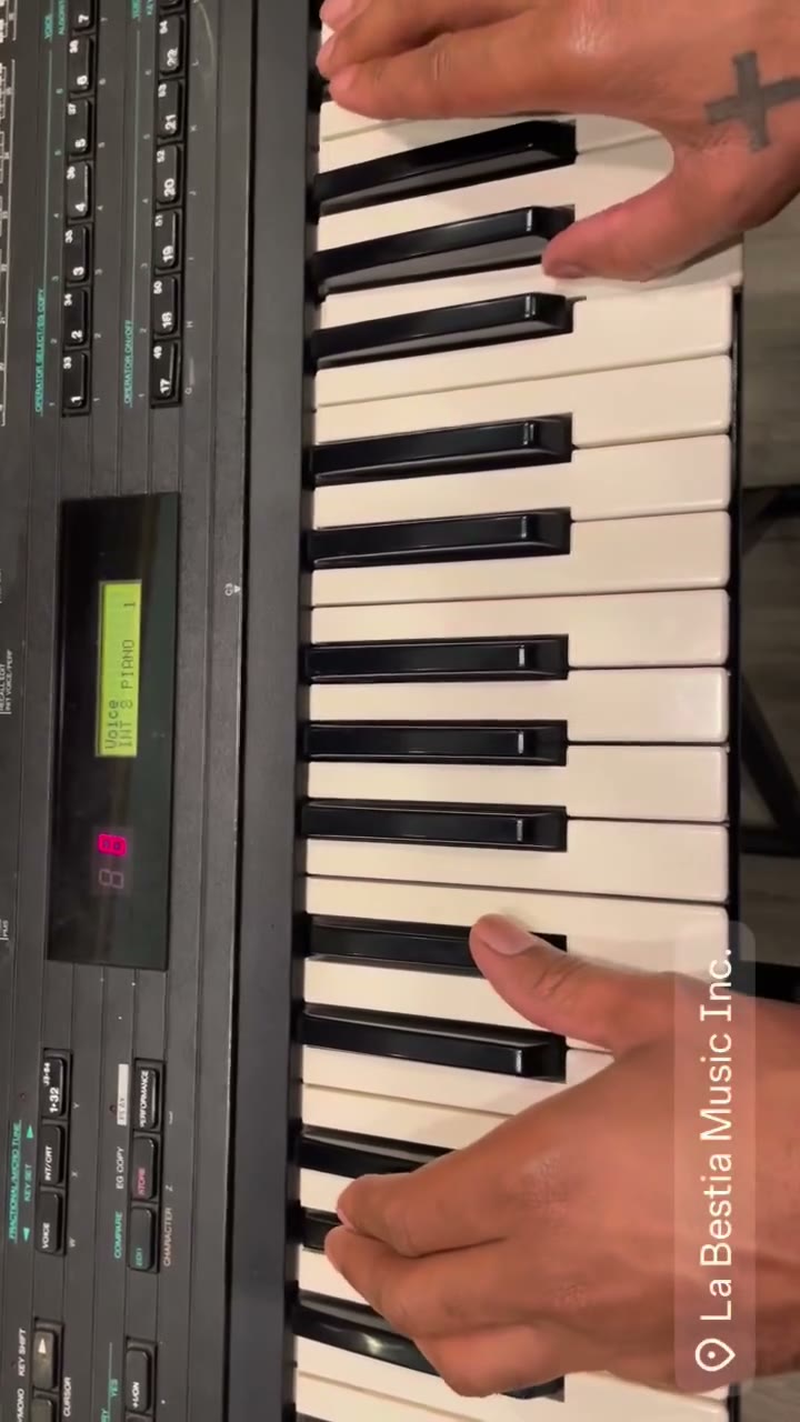 Hands playing an upright piano in a rented room at La Bestia Music Inc., Mexico City.